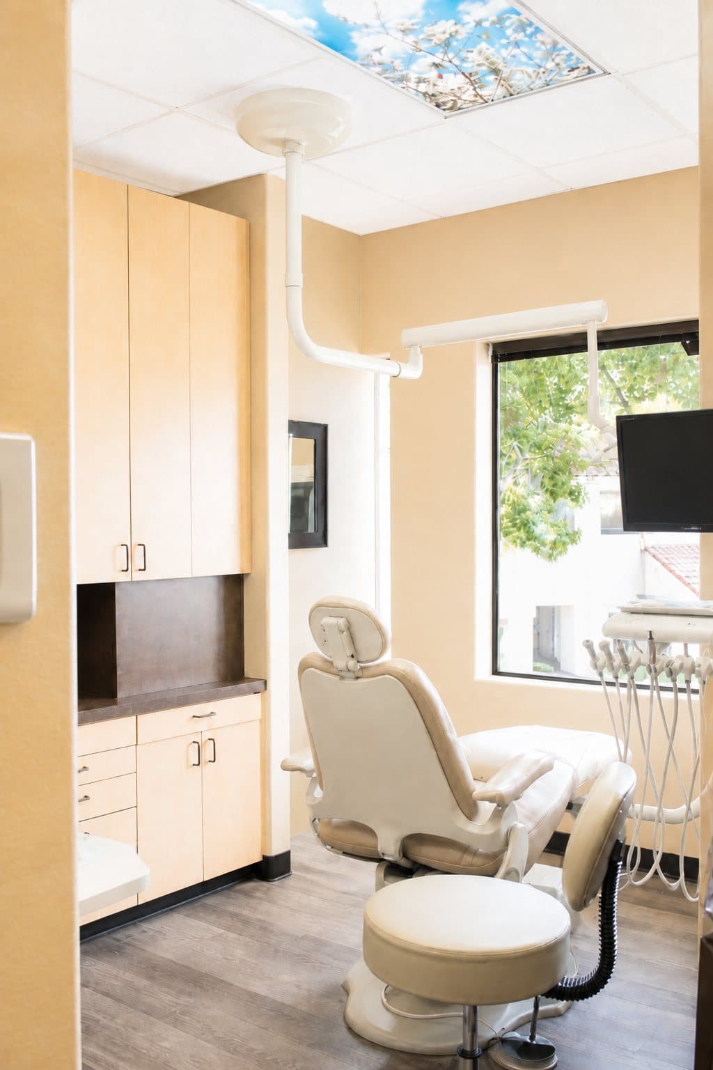 Treatment bay with a beige chair and window light